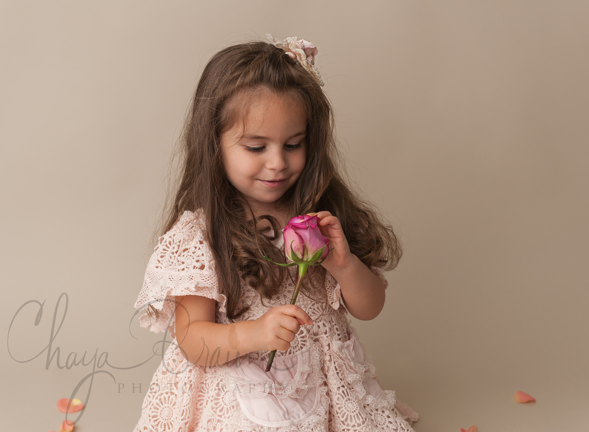 little girl holding pink rose
