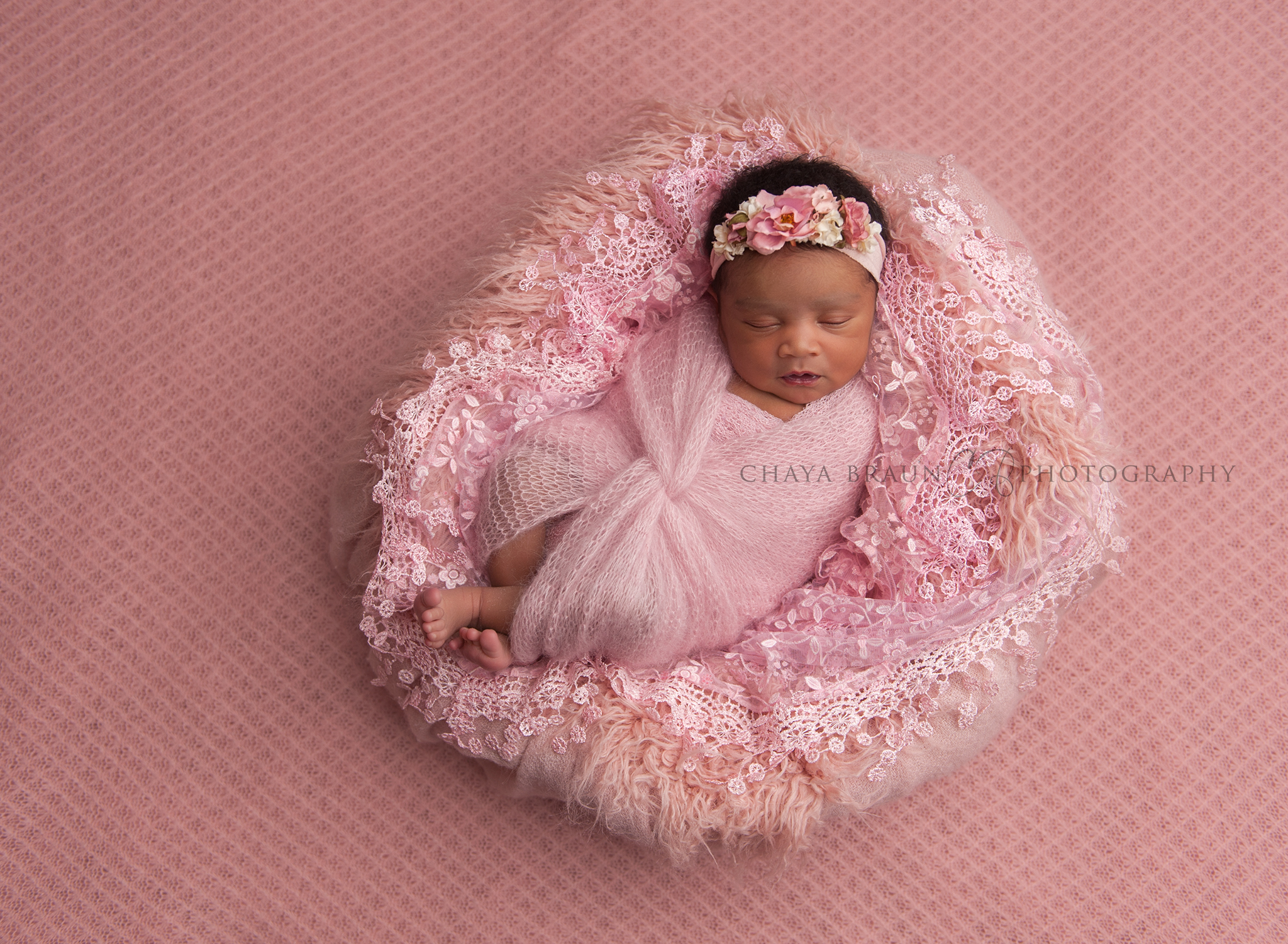 newborn baby girl in pink basket photo
