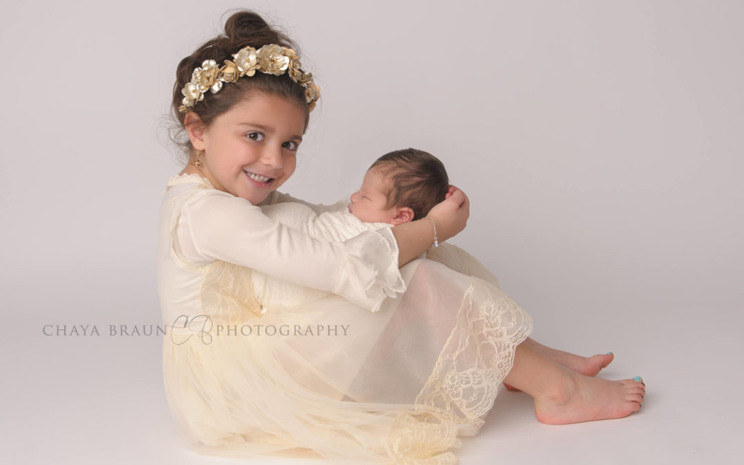 Newborn Photography – Sister with her new baby brother