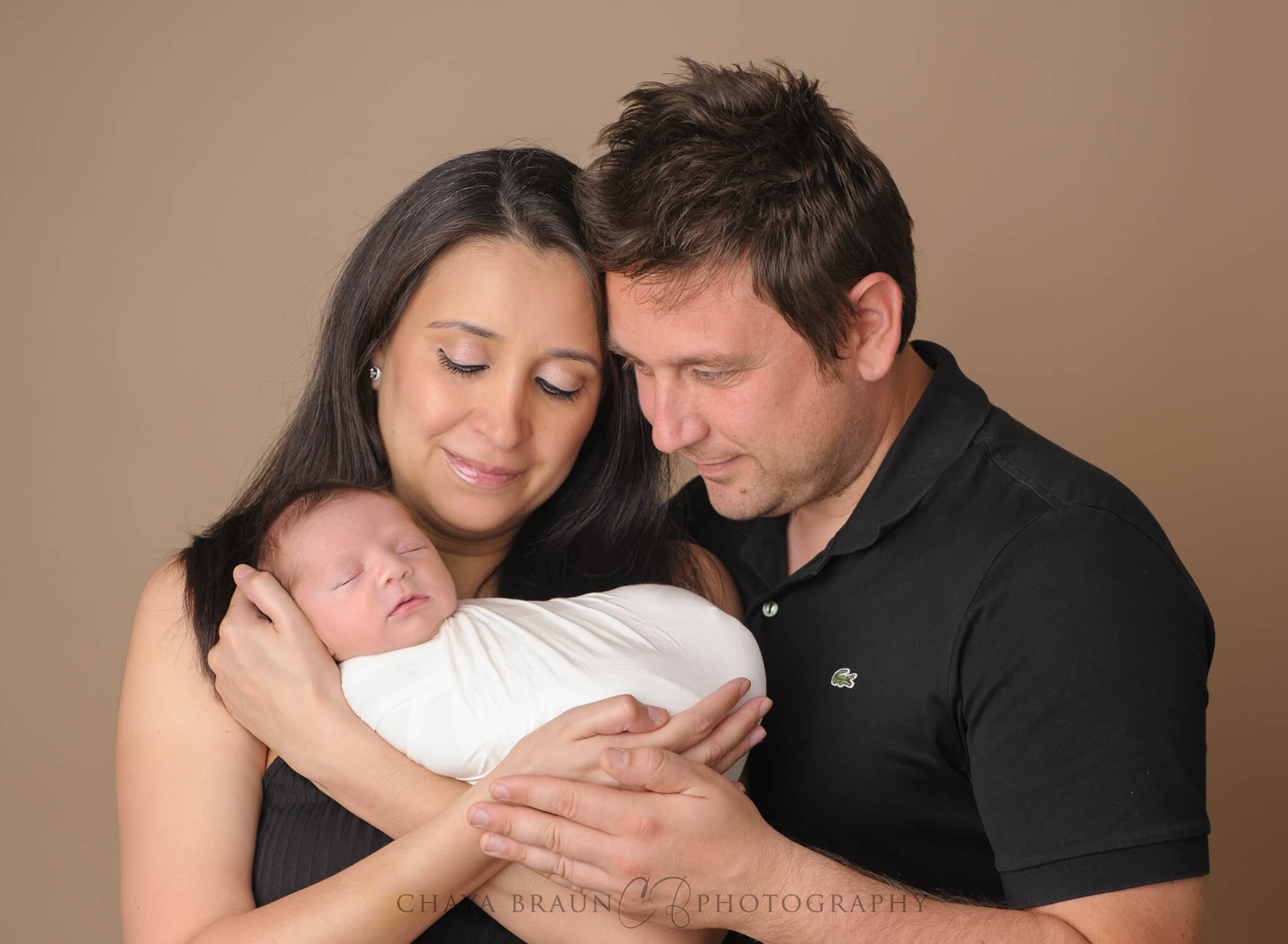 parents and newborn baby posing