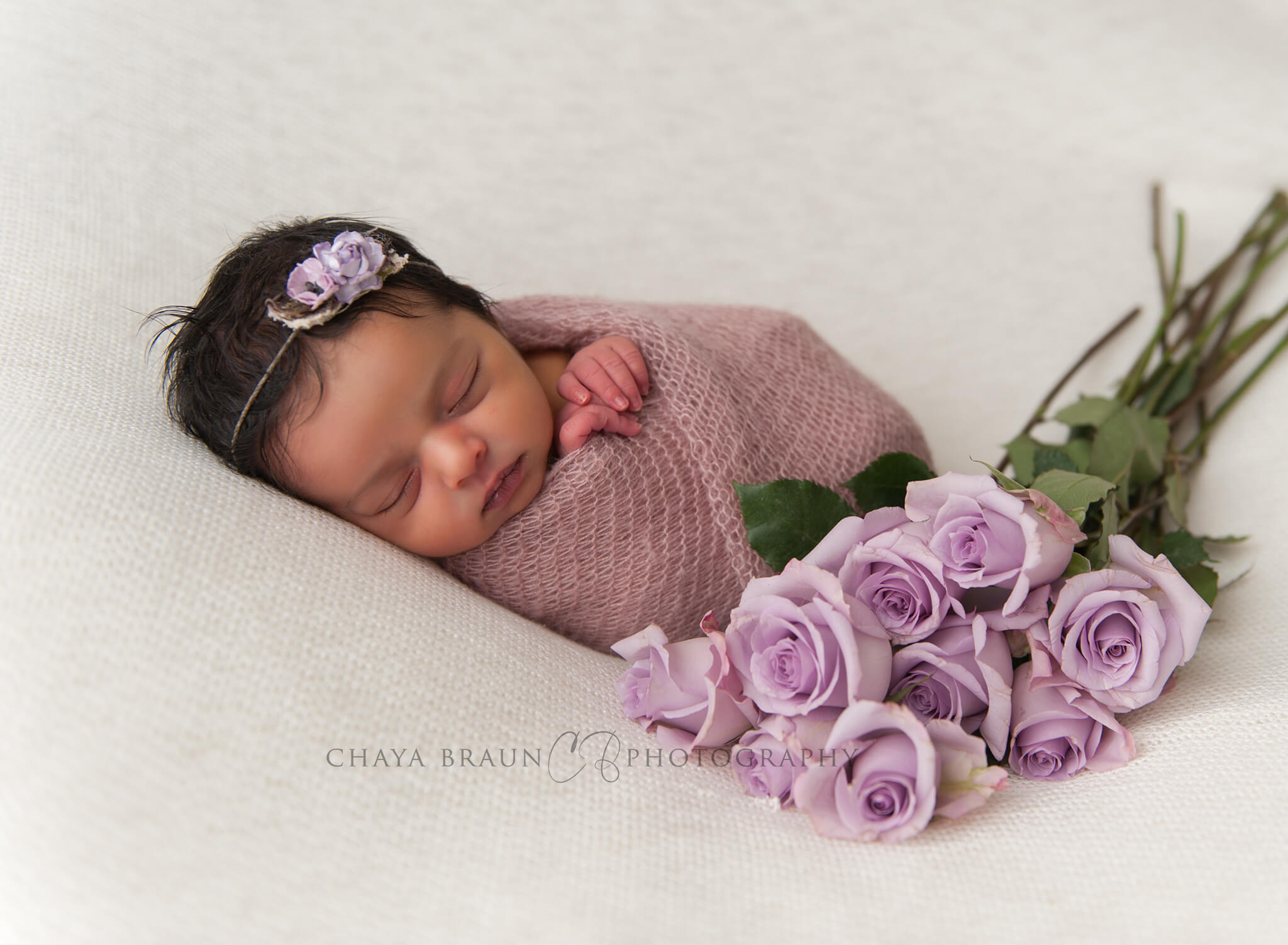 sleeping newborn baby with flowers