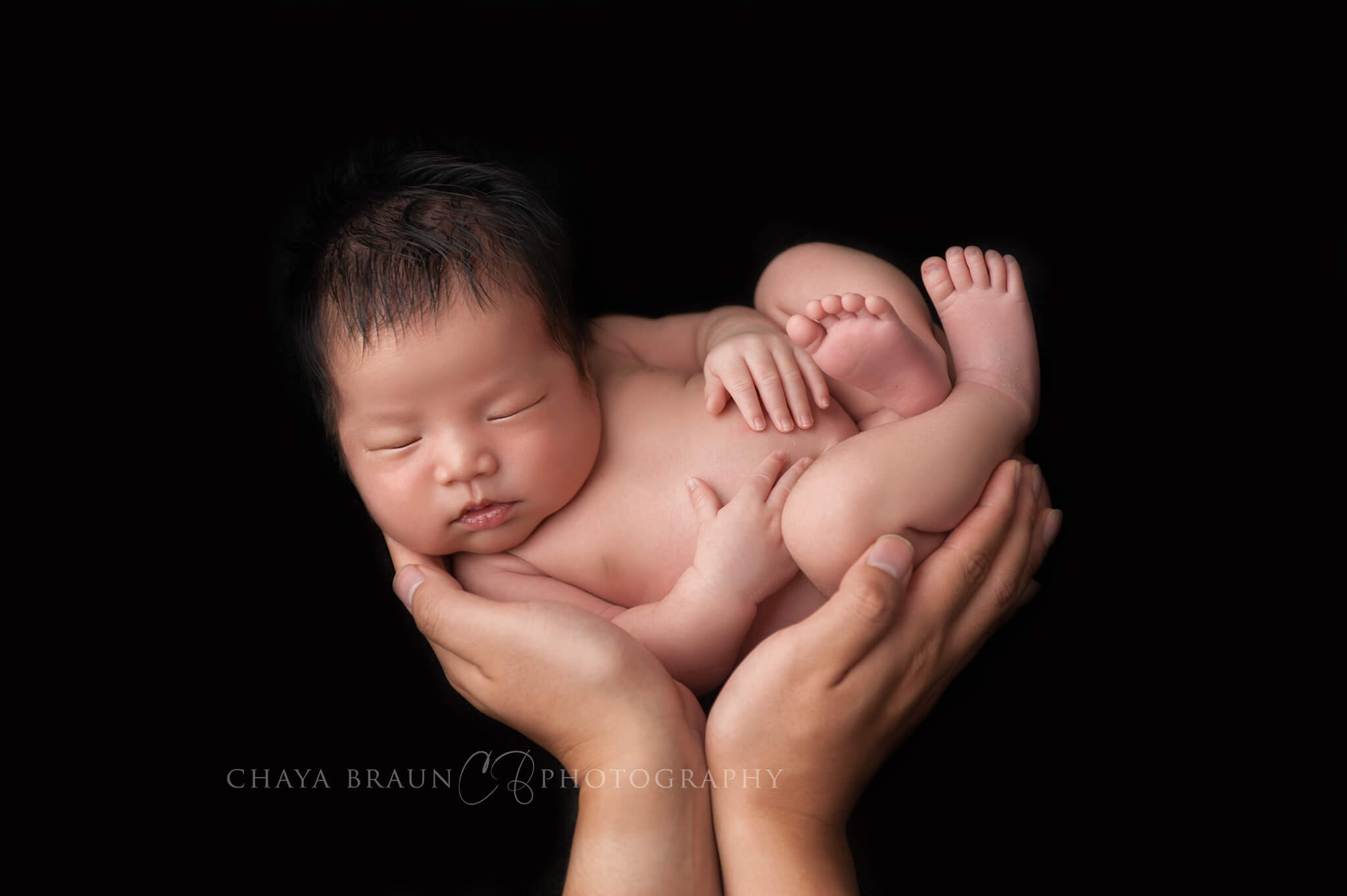 newborn baby in dad's hands