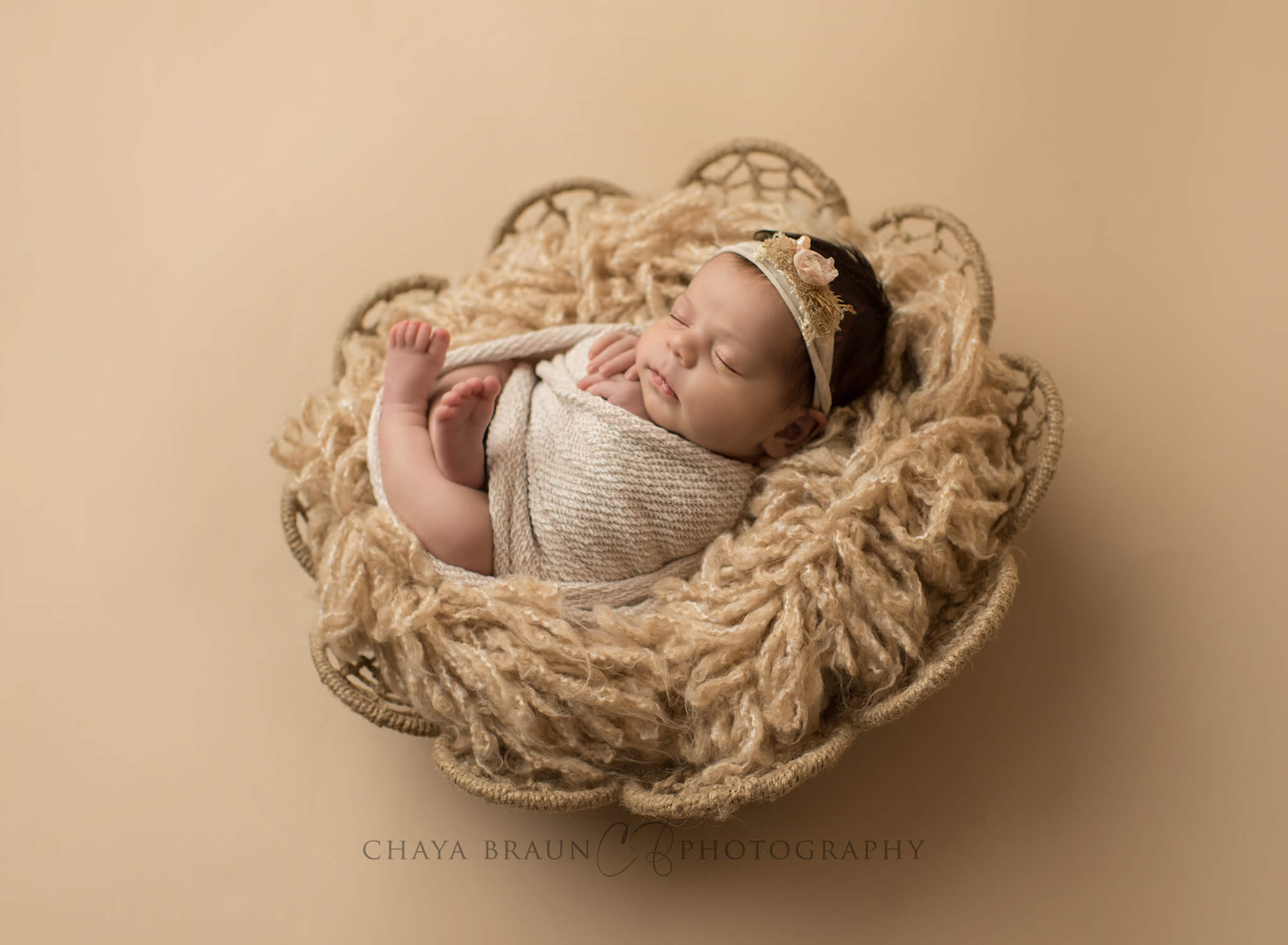 backlit newborn baby in basket